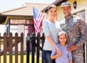 Military family in front of a house